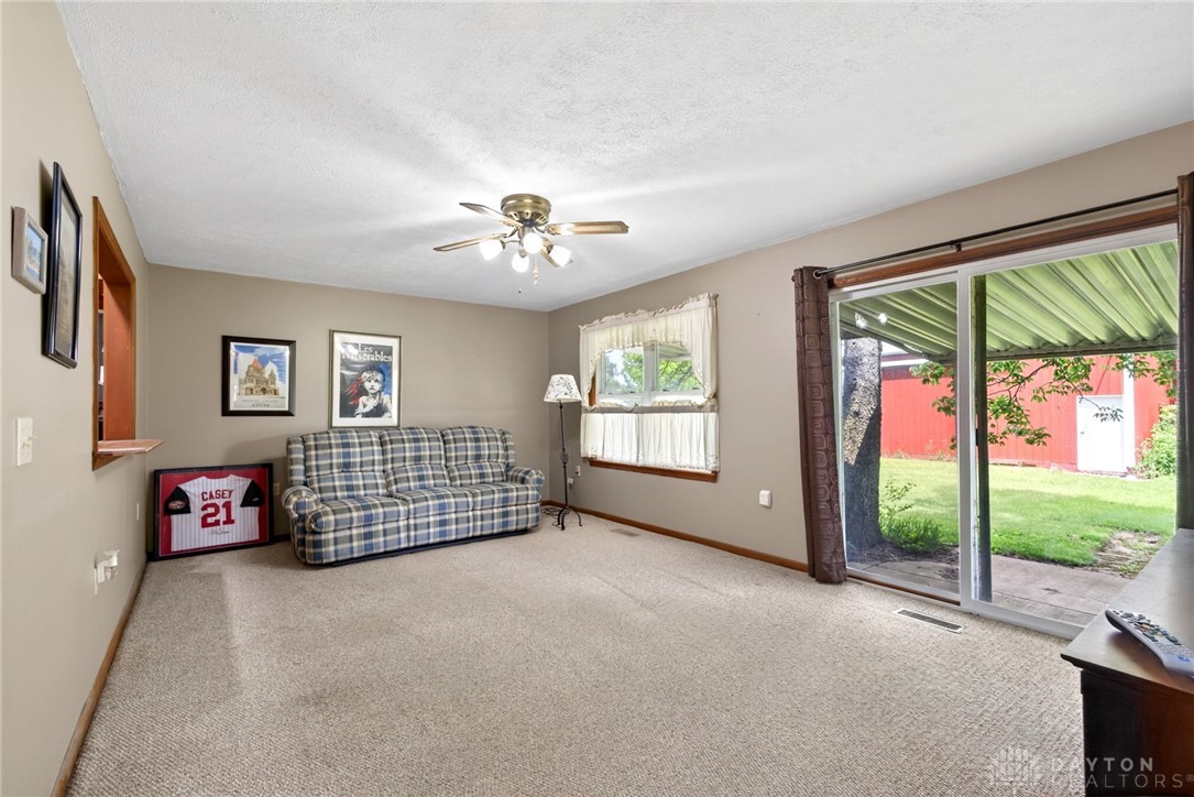 2470 Clark Run Road Xenia, OH 45385 - Photo 13 of 57 This living room provides a comfortable space with direct access to the outdoors.