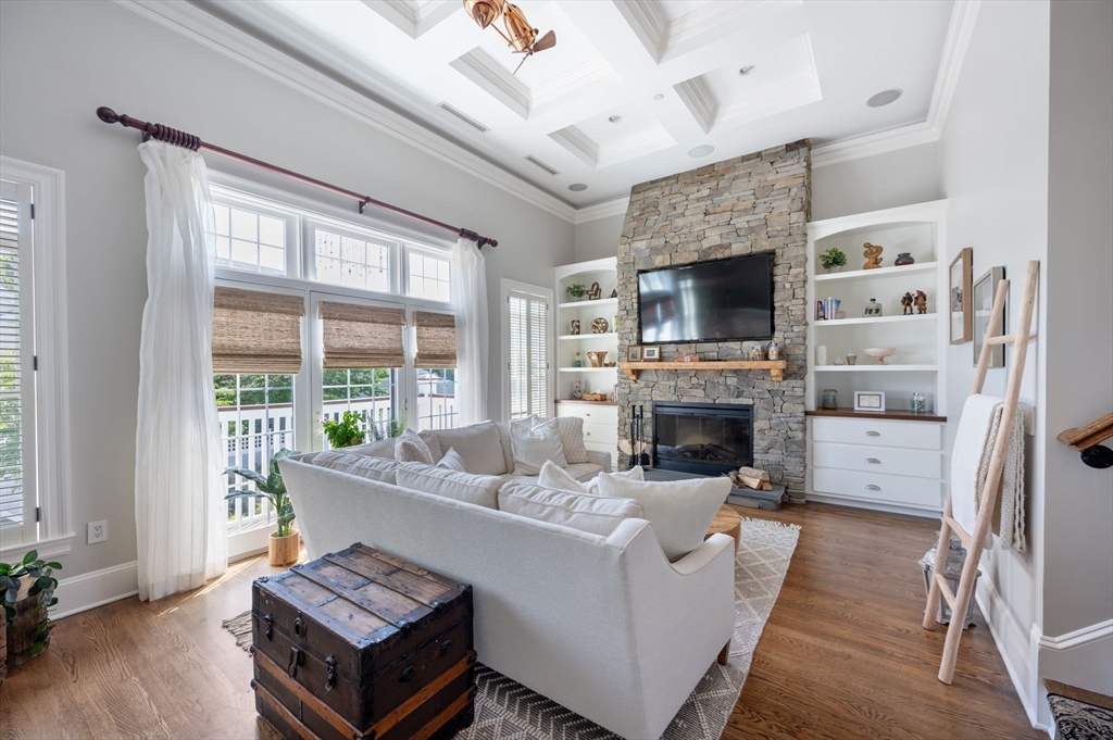 221 Victory Road, Unit 221 Quincy, MA 02171 - Photo 1 of 34 a living room with furniture a flat screen tv and a fireplace
