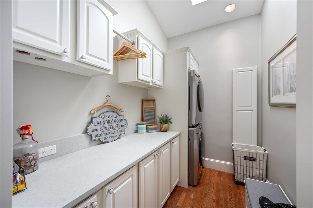 221 Victory Road, Unit 221 Quincy, MA 02171 - Photo 11 of 34 a kitchen with stainless steel appliances granite countertop a refrigerator and a stove top oven