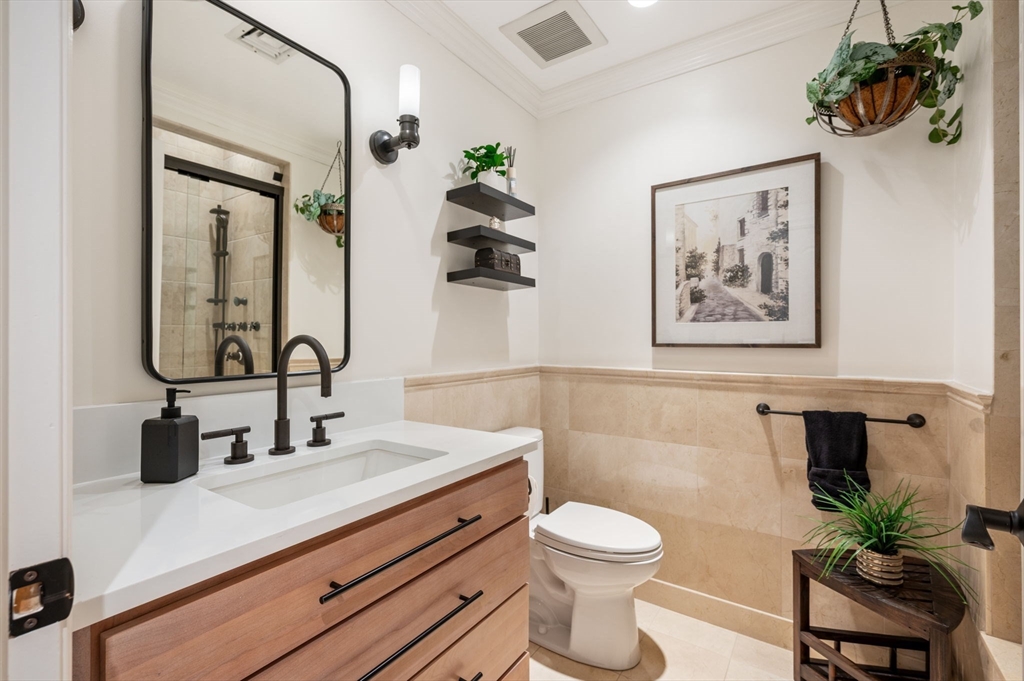 221 Victory Road, Unit 221 Quincy, MA 02171 - Photo 15 of 34 a bathroom with a toilet sink and mirror