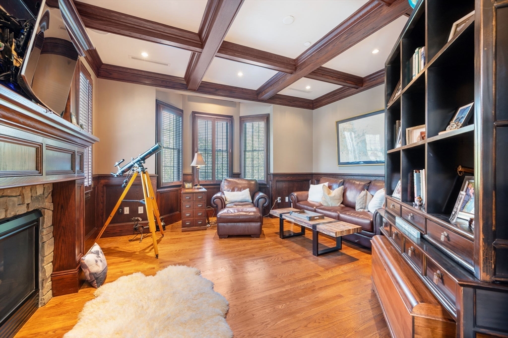 221 Victory Road, Unit 221 Quincy, MA 02171 - Photo 16 of 34 a living room with furniture a flat screen tv and a fireplace