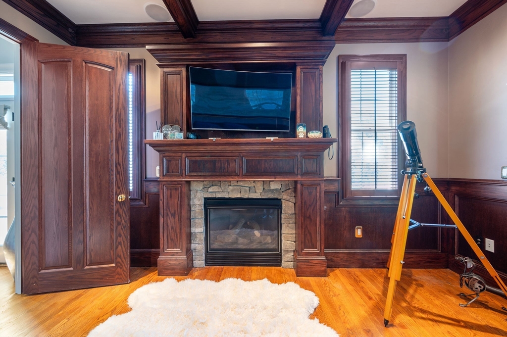 221 Victory Road, Unit 221 Quincy, MA 02171 - Photo 17 of 34 a living room with a fireplace and a flat screen tv