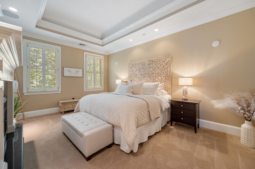 221 Victory Road, Unit 221 Quincy, MA 02171 - Photo 18 of 34 a bedroom with a bed and a night stand