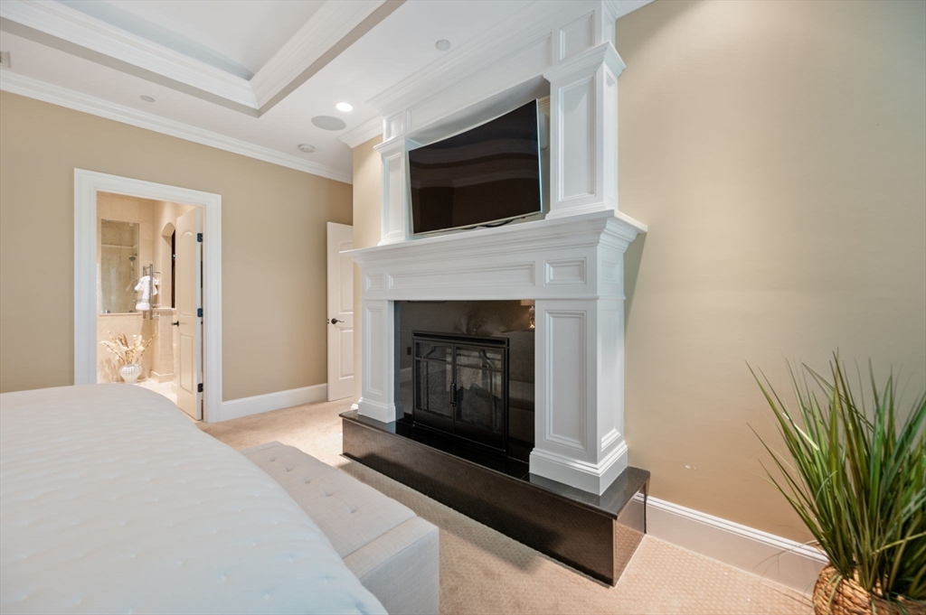 221 Victory Road, Unit 221 Quincy, MA 02171 - Photo 19 of 34 a living room with a fireplace and a flat screen tv