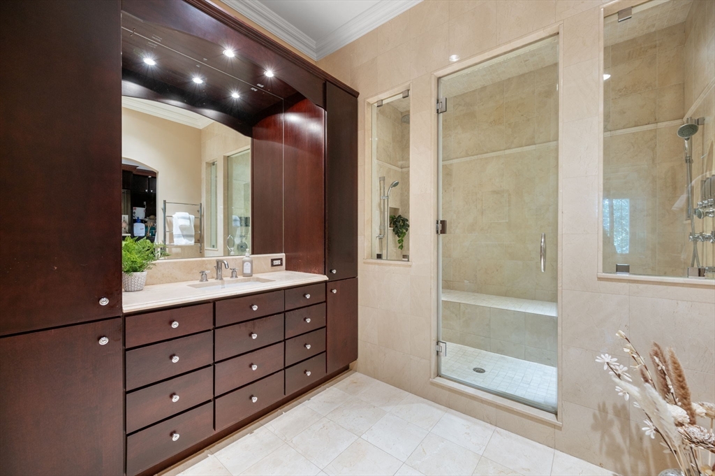 221 Victory Road, Unit 221 Quincy, MA 02171 - Photo 20 of 34 a bathroom with a double vanity sink and a shower