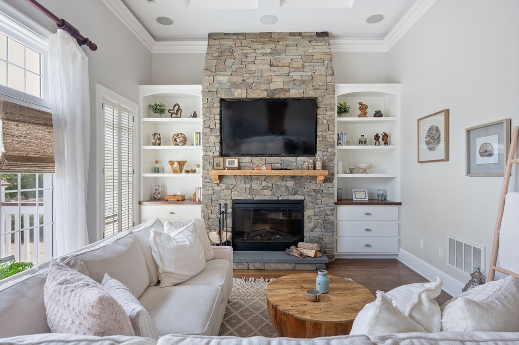 221 Victory Road, Unit 221 Quincy, MA 02171 - Photo 2 of 34 a living room with furniture a flat screen tv and a fireplace