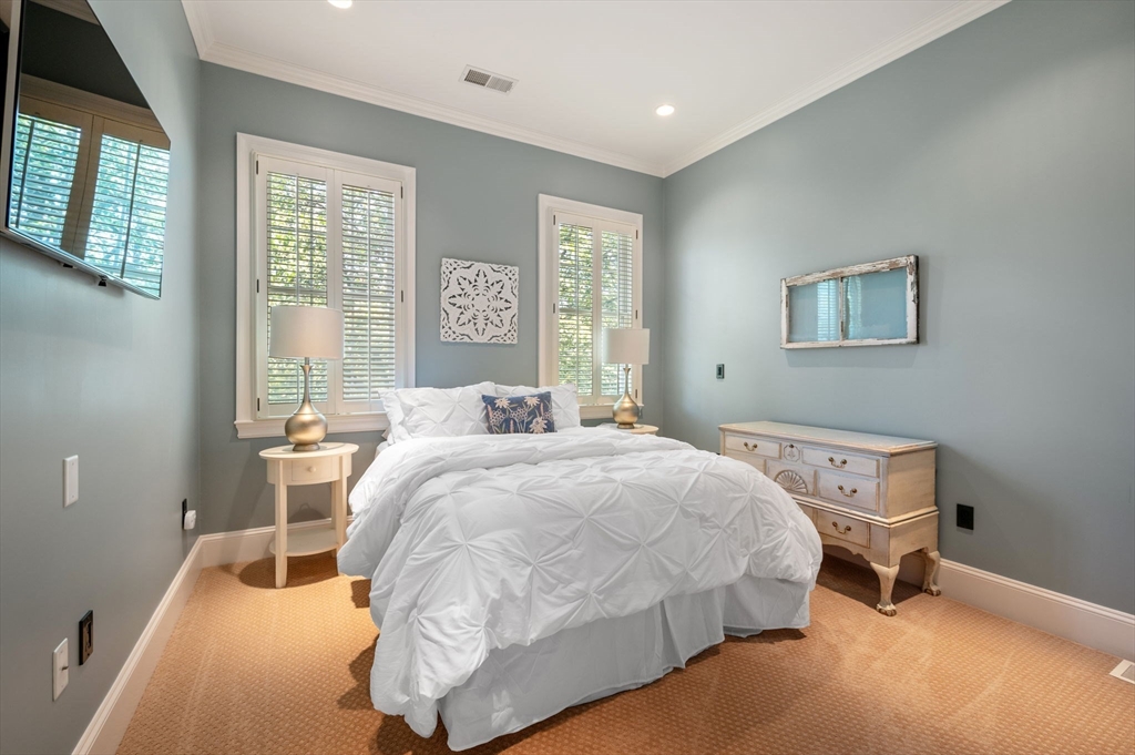 221 Victory Road, Unit 221 Quincy, MA 02171 - Photo 23 of 34 a bedroom with a bed and wooden floor