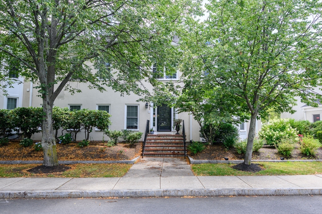 221 Victory Road, Unit 221 Quincy, MA 02171 - Photo 26 of 34 a front view of a house with garden