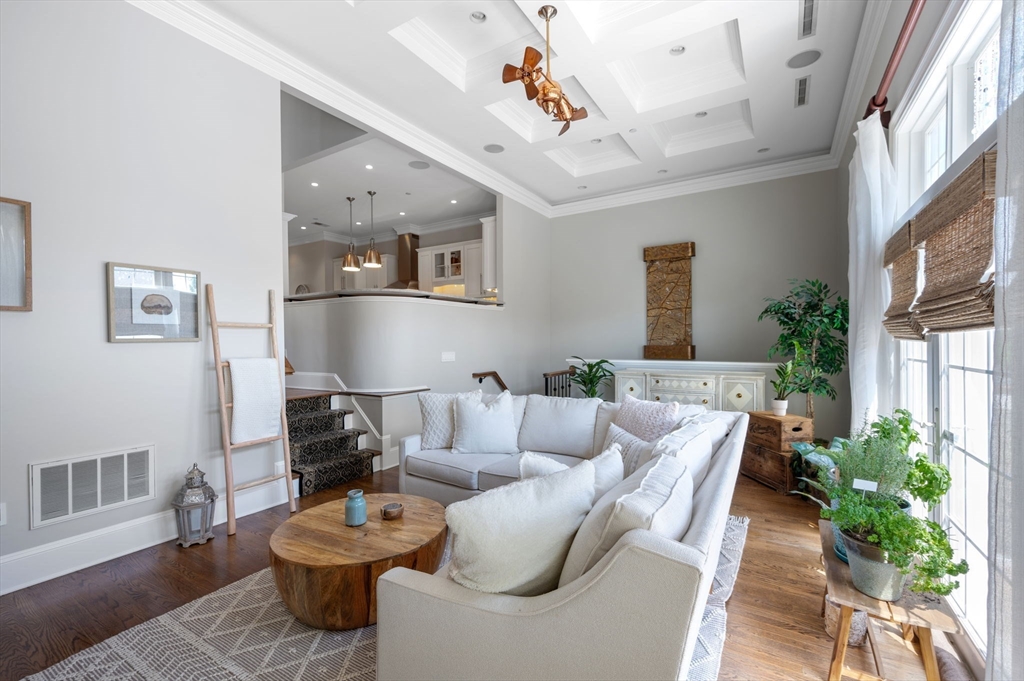 221 Victory Road, Unit 221 Quincy, MA 02171 - Photo 3 of 34 a living room with furniture and a potted plant