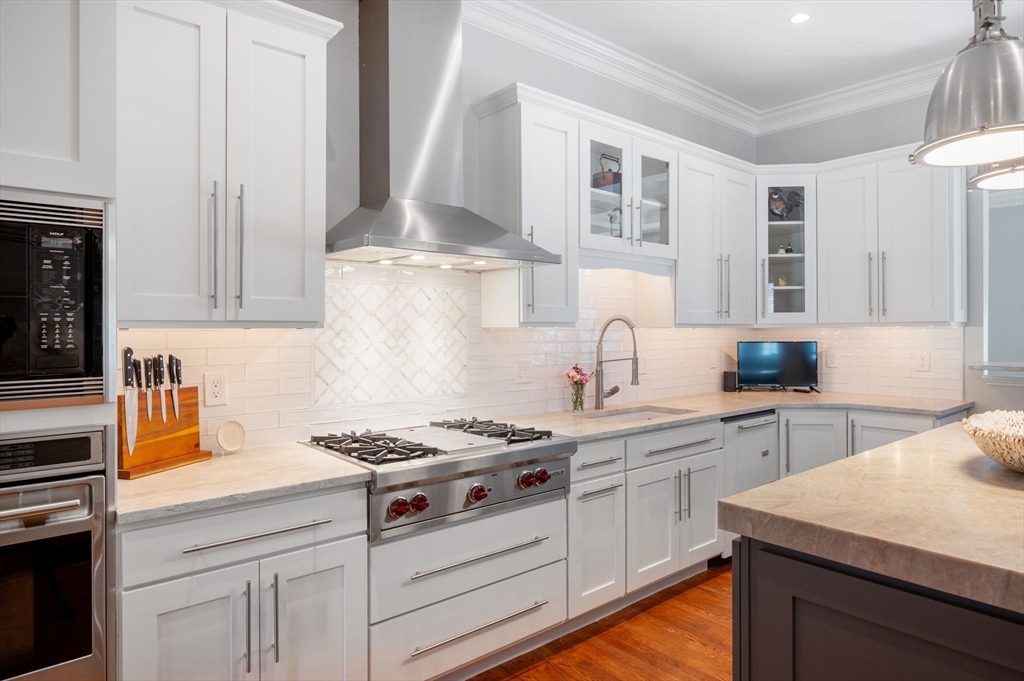 221 Victory Road, Unit 221 Quincy, MA 02171 - Photo 6 of 34 a kitchen with cabinets appliances a sink and a counter space