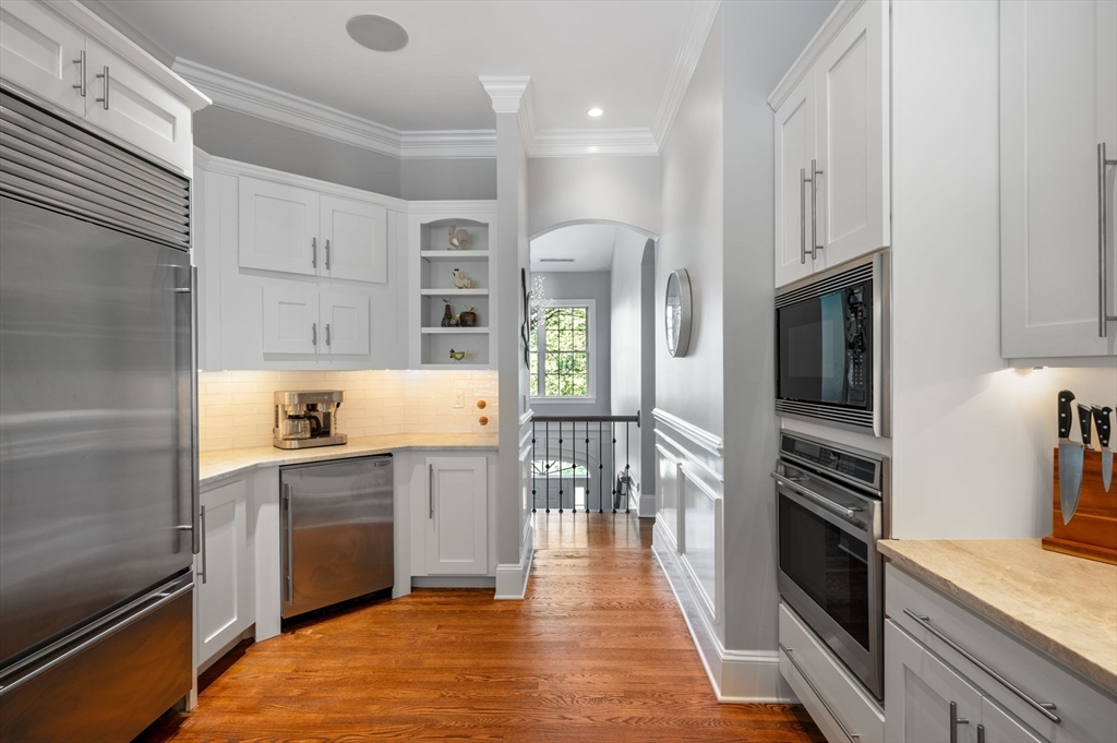 221 Victory Road, Unit 221 Quincy, MA 02171 - Photo 9 of 34 a kitchen with stainless steel appliances granite countertop a refrigerator and a stove top oven