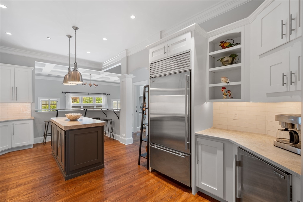 221 Victory Road, Unit 221 Quincy, MA 02171 - Photo 10 of 34 a kitchen with kitchen island a counter top space a sink stainless steel appliances and cabinets
