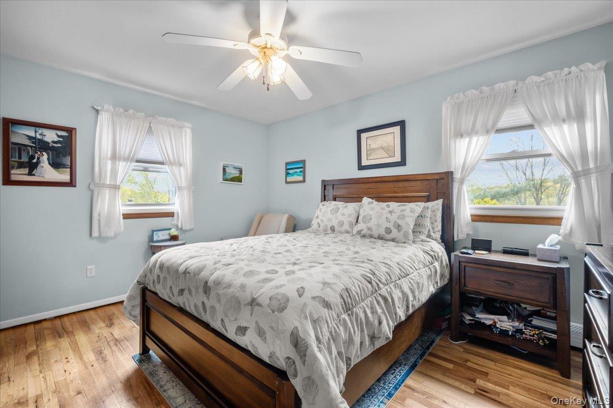 10 Richard Road Mahopac, NY 10541 - Photo 12 of 33 Bedroom with light wood-style flooring, ceiling fan, and baseboard heating