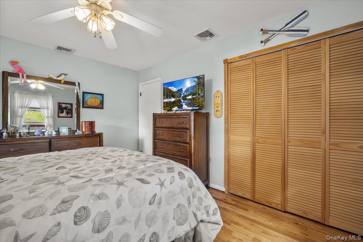 10 Richard Road Mahopac, NY 10541 - Photo 13 of 33 Bedroom featuring light wood-type flooring, a closet, and a ceiling fan