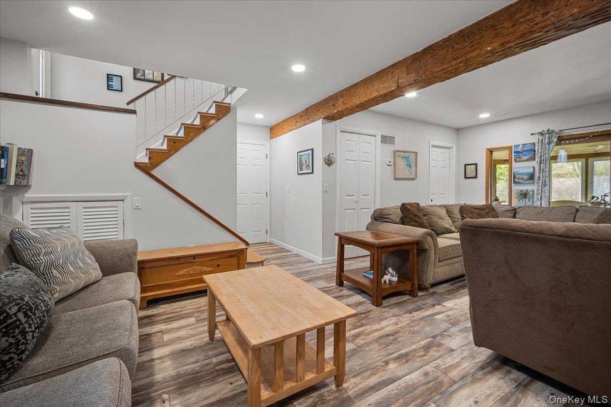 10 Richard Road Mahopac, NY 10541 - Photo 20 of 33 Living area with beamed ceiling, wood finished floors, recessed lighting, and stairs
