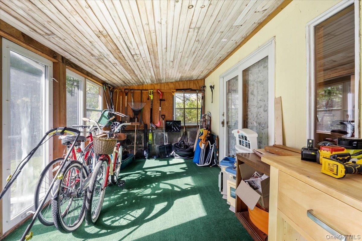 10 Richard Road Mahopac, NY 10541 - Photo 23 of 33 Sunroom / solarium featuring healthy amount of natural light, carpet, wooden ceiling, wooden walls, and vaulted ceiling