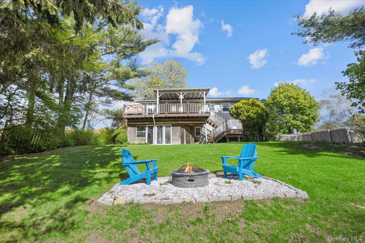 10 Richard Road Mahopac, NY 10541 - Photo 25 of 33 Back of house featuring a wooden deck, stairway, a lawn, and a patio