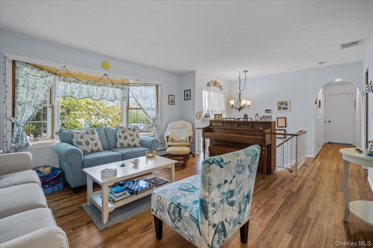 10 Richard Road Mahopac, NY 10541 - Photo 3 of 33 Living room featuring arched walkways and wood finished floors