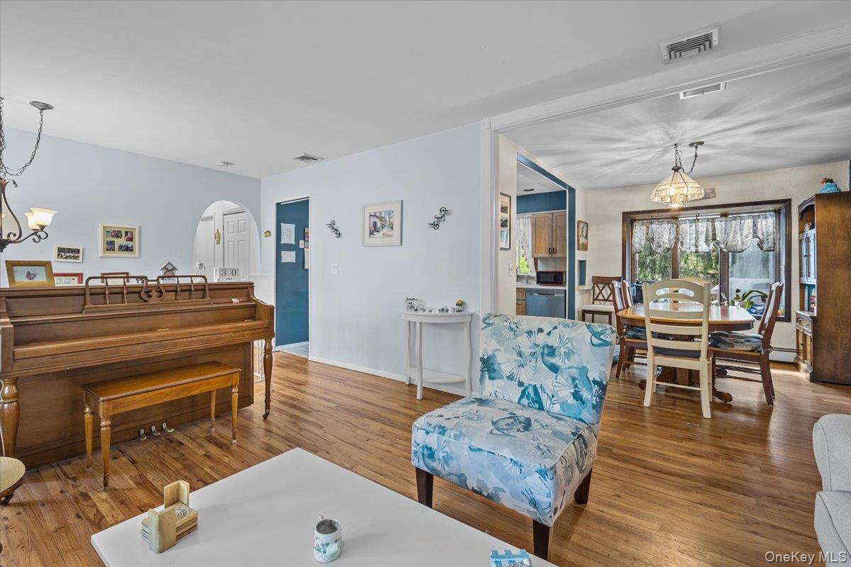 10 Richard Road Mahopac, NY 10541 - Photo 4 of 33 Living room with a chandelier and wood finished floors