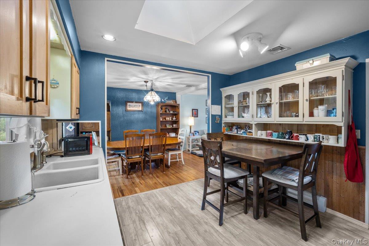 10 Richard Road Mahopac, NY 10541 - Photo 10 of 33 Dining space featuring light wood finished floors, a chandelier, recessed lighting, and a baseboard radiator