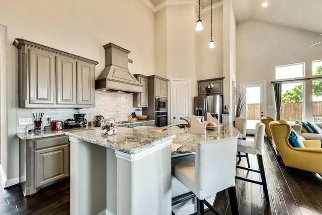 a kitchen with a sink stove and cabinets
