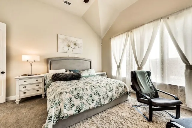 a bedroom with furniture and a window