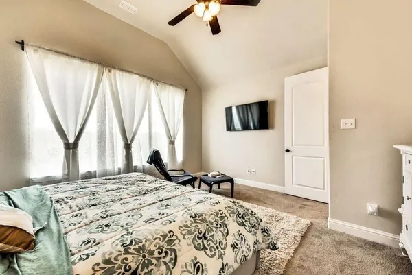 a bedroom with a bed and a chair