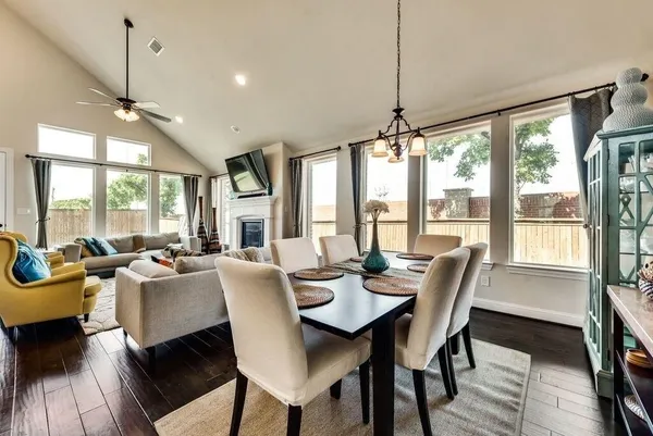 a view of a dining room with furniture large windows and wooden floor