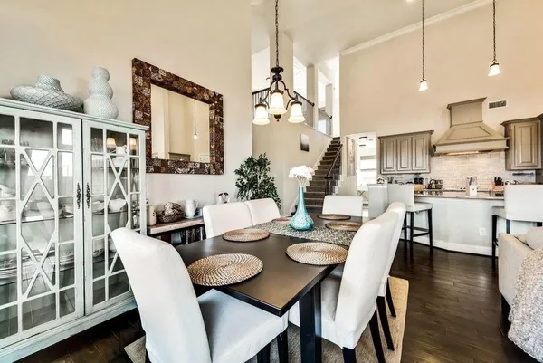 a view of a dining room with furniture wooden floor and chandelier