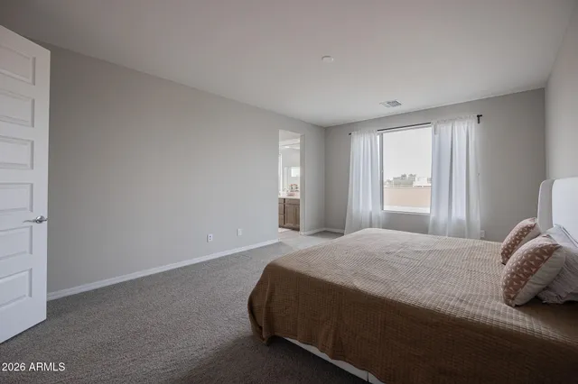 a bedroom with a bed and window