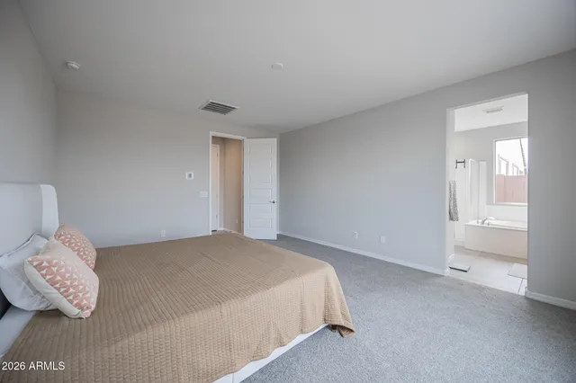 a bedroom with a bed and a couch