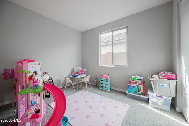 a bedroom with toys and a wooden floor