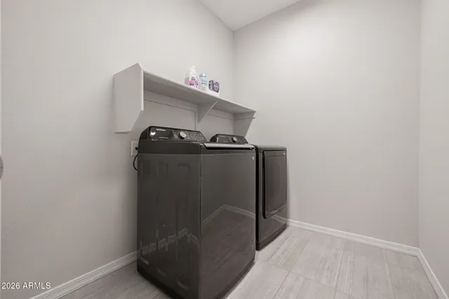 a close up of a utility room with washer and dryer