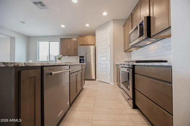 a kitchen with a sink stove and refrigerator