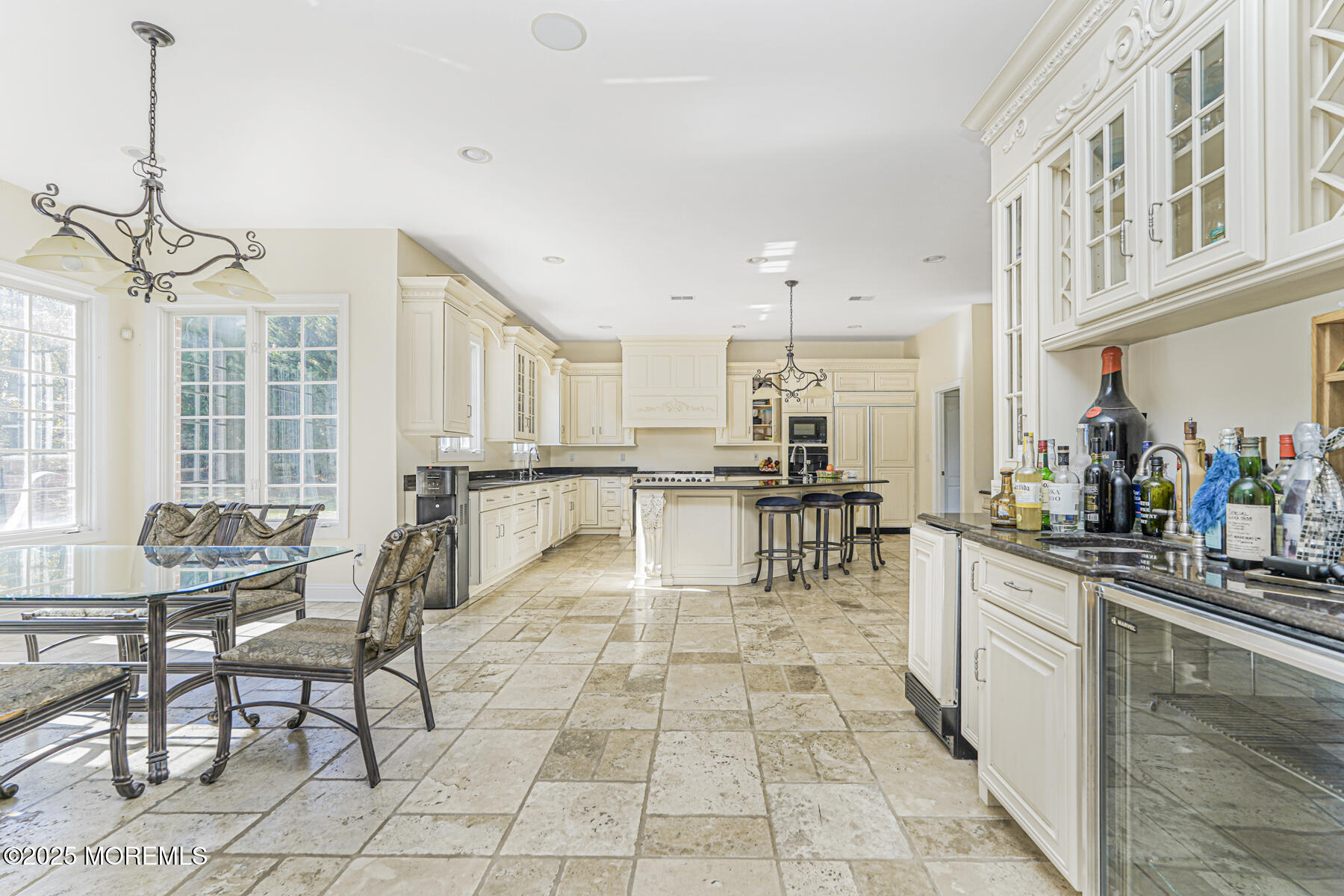 97 Stone Hill Road Colts Neck, NJ 07722 - Photo 23 of 51 a kitchen with stainless steel appliances kitchen island granite countertop a stove a sink a dining table and chairs with wooden floor