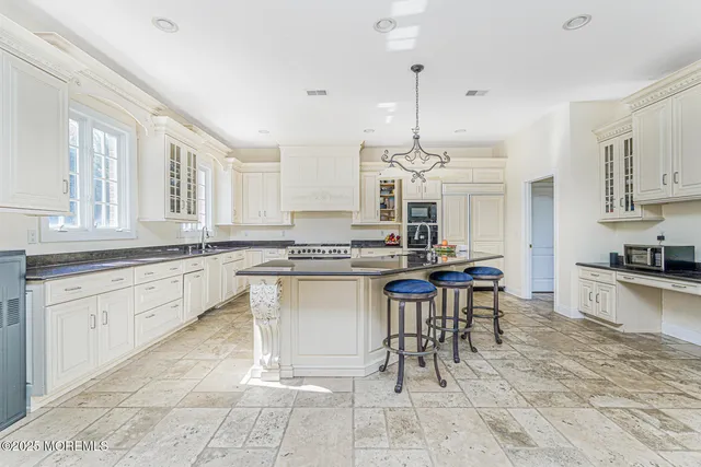 a kitchen with stainless steel appliances granite countertop a sink stove and cabinets