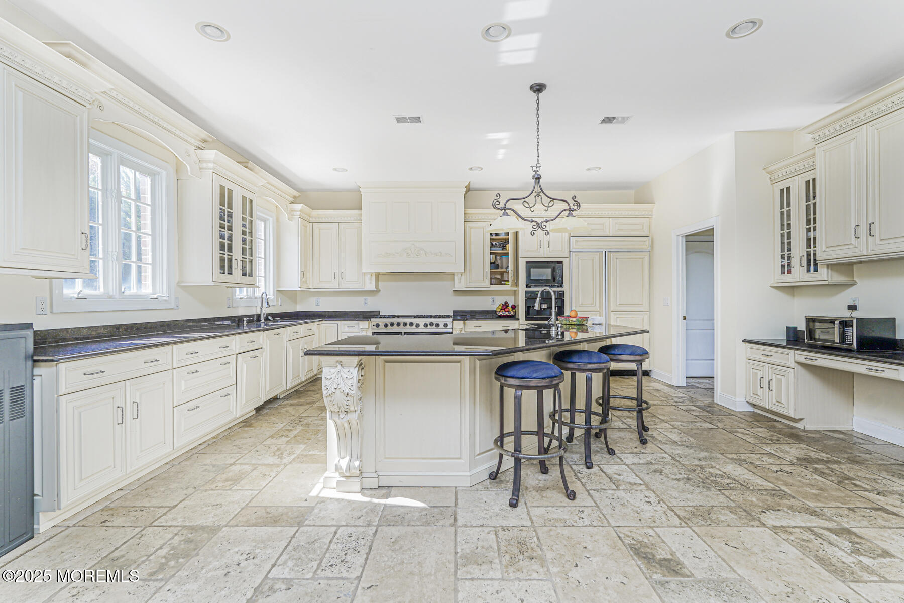 97 Stone Hill Road Colts Neck, NJ 07722 - Photo 24 of 51 a large kitchen with kitchen island a sink table and chairs
