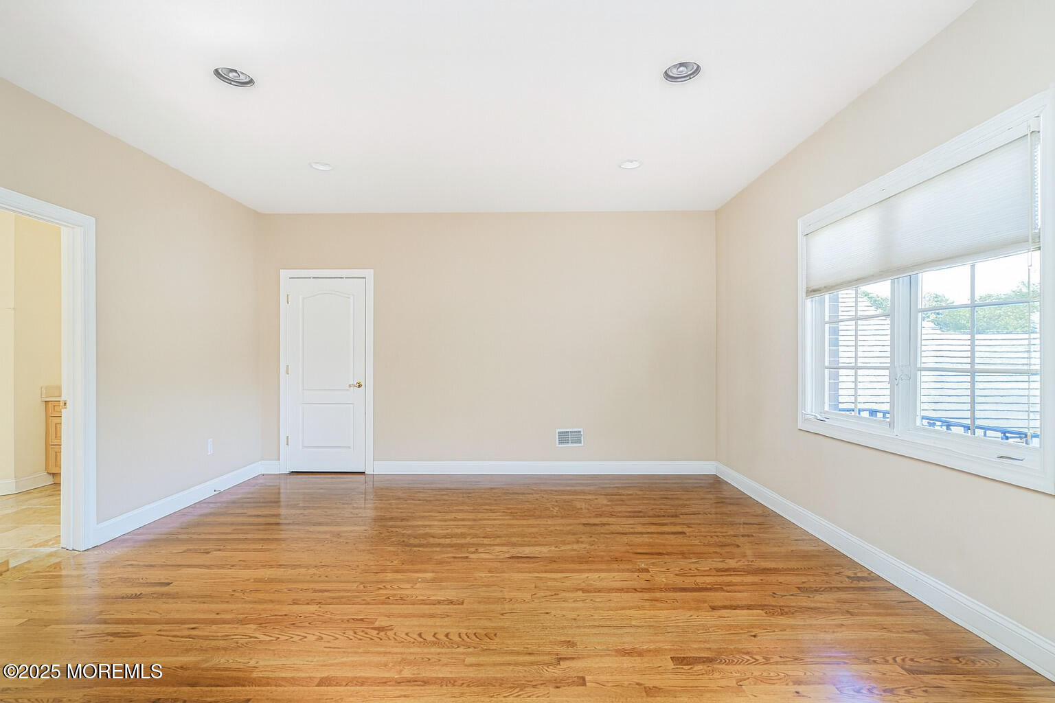 97 Stone Hill Road Colts Neck, NJ 07722 - Photo 38 of 51 a view of an empty room with wooden floor and a window