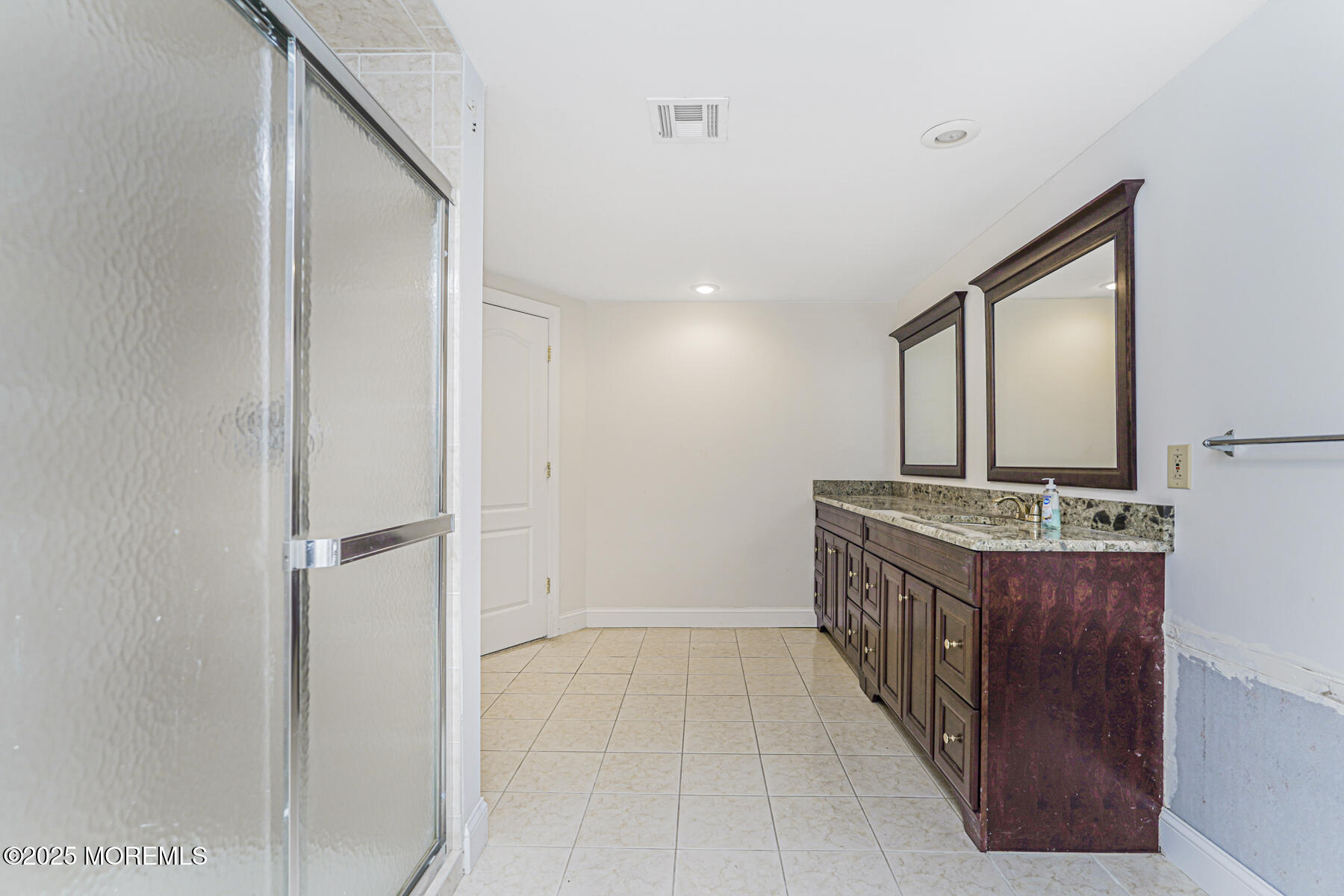 97 Stone Hill Road Colts Neck, NJ 07722 - Photo 46 of 51 a view of a hallway with a sink and a refrigerator