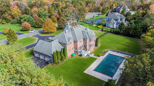 an aerial view of a house with garden space sitting space and swimming pool