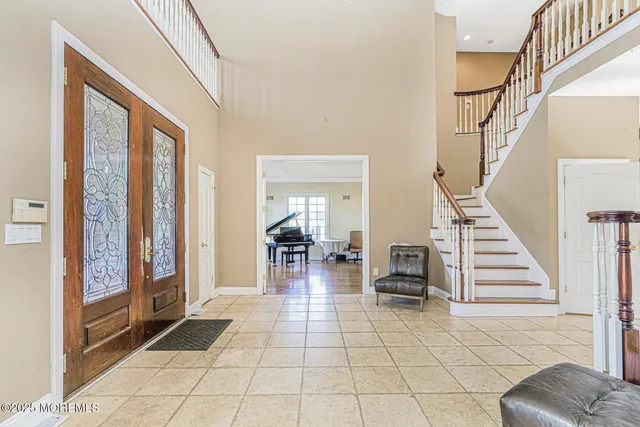 a living room with furniture and a floor to ceiling window