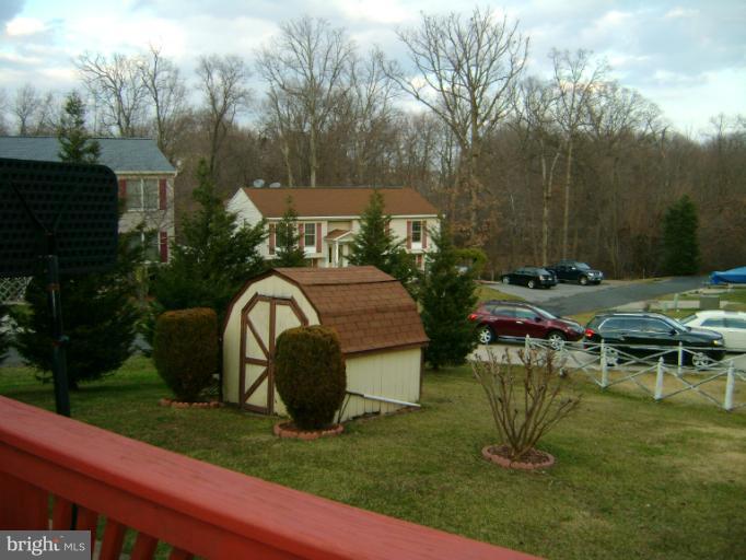 2215 Wilhelm Avenue Rosedale, MD 21237 - Photo 4 of 12 a backyard of a house with yard and outdoor seating