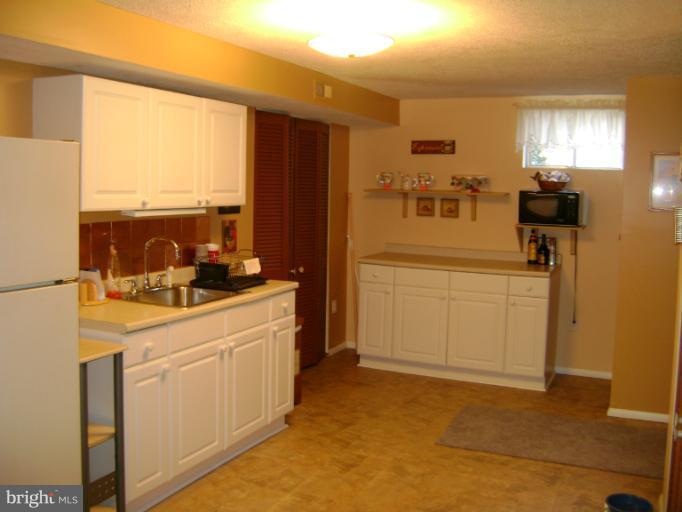 2215 Wilhelm Avenue Rosedale, MD 21237 - Photo 8 of 12 a kitchen with a sink and refrigerator