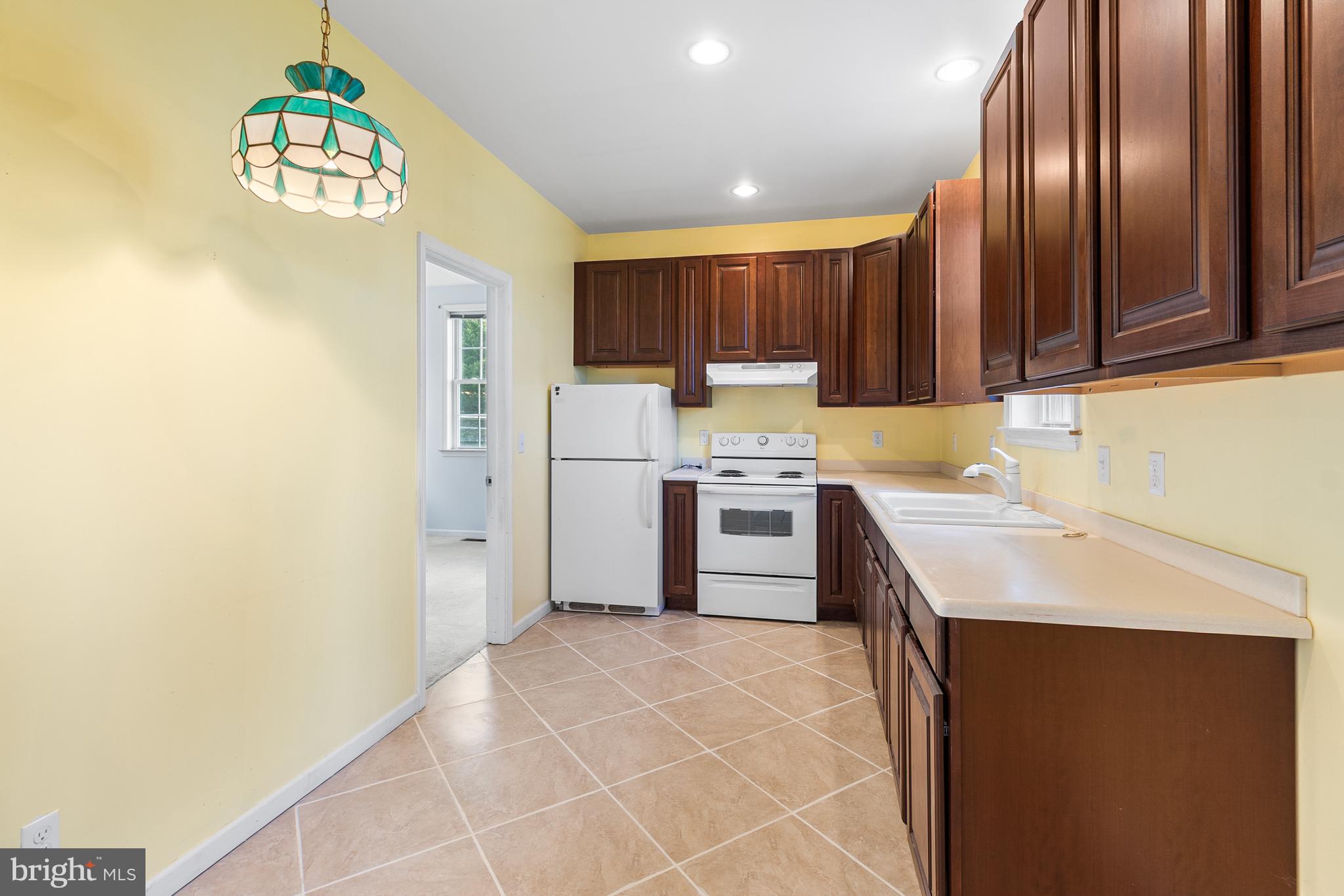 8 Peacock Place Newark, DE 19711 - Photo 34 of 70 a kitchen with a refrigerator and a sink
