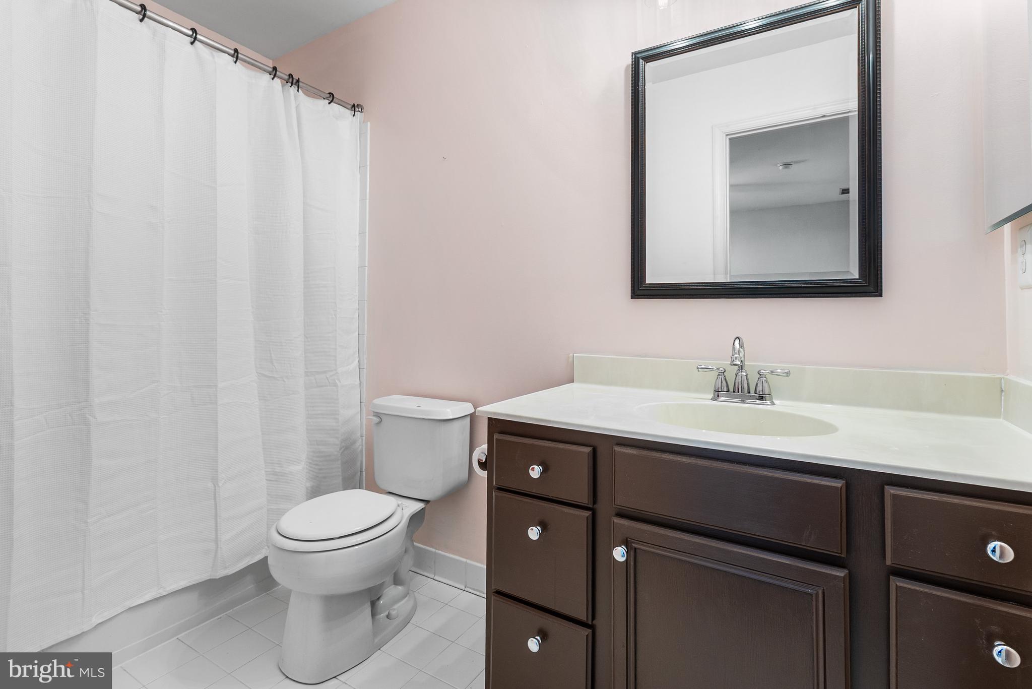 8 Peacock Place Newark, DE 19711 - Photo 56 of 70 a bathroom with a toilet sink and mirror