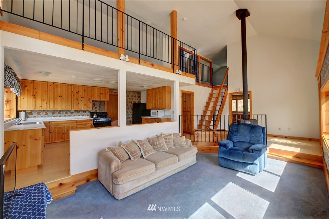 137 Jason Lucas Road Methow, WA 98834 - Photo 14 of 36 a living room with furniture and a fireplace