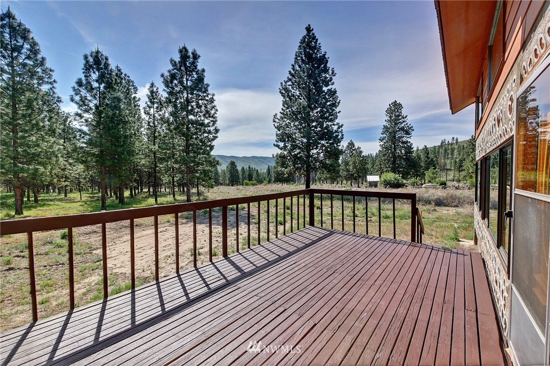 137 Jason Lucas Road Methow, WA 98834 - Photo 8 of 36 a balcony with wooden floor and outdoor space