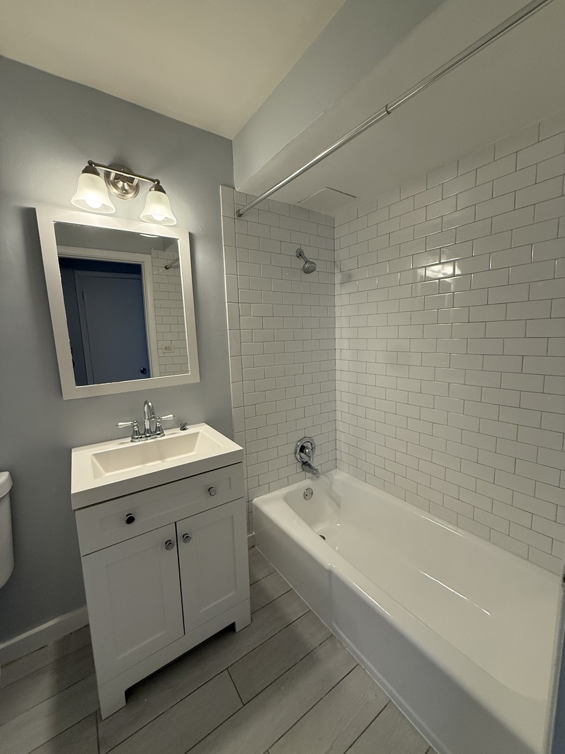 2124 14th Avenue, Unit 1S Broadview, IL 60155 - Photo 4 of 7 a bathroom with a tub sink double and mirror