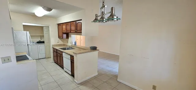 a kitchen with granite countertop a stove and a refrigerator