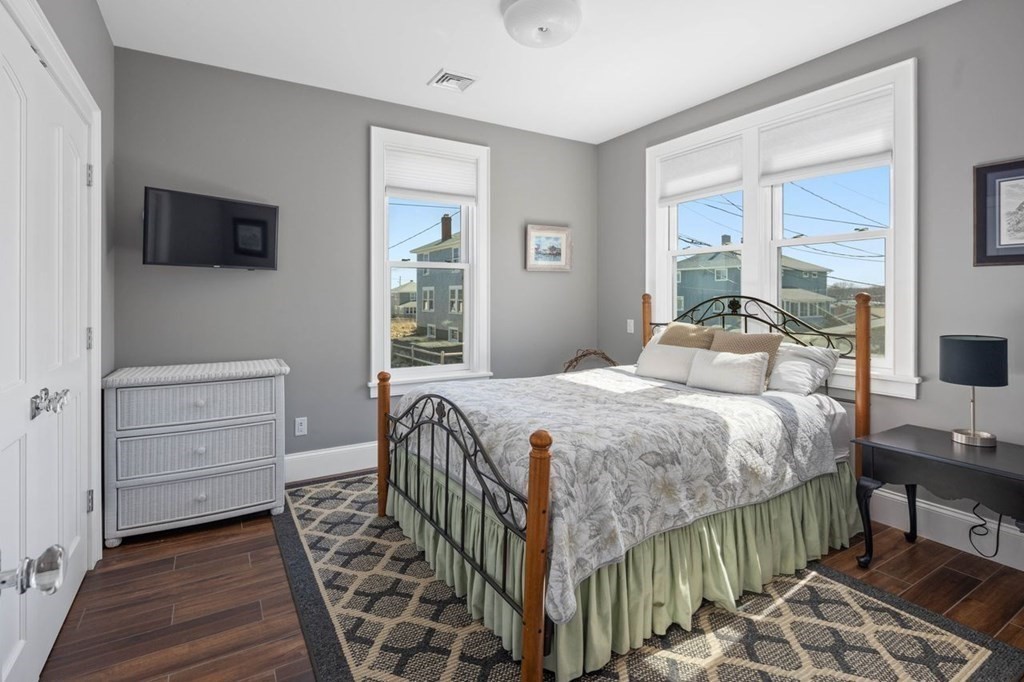 12 Monitor Road Marshfield, MA 02050 - Photo 24 of 38 a bedroom with a bed and a flat tv screen on dresser